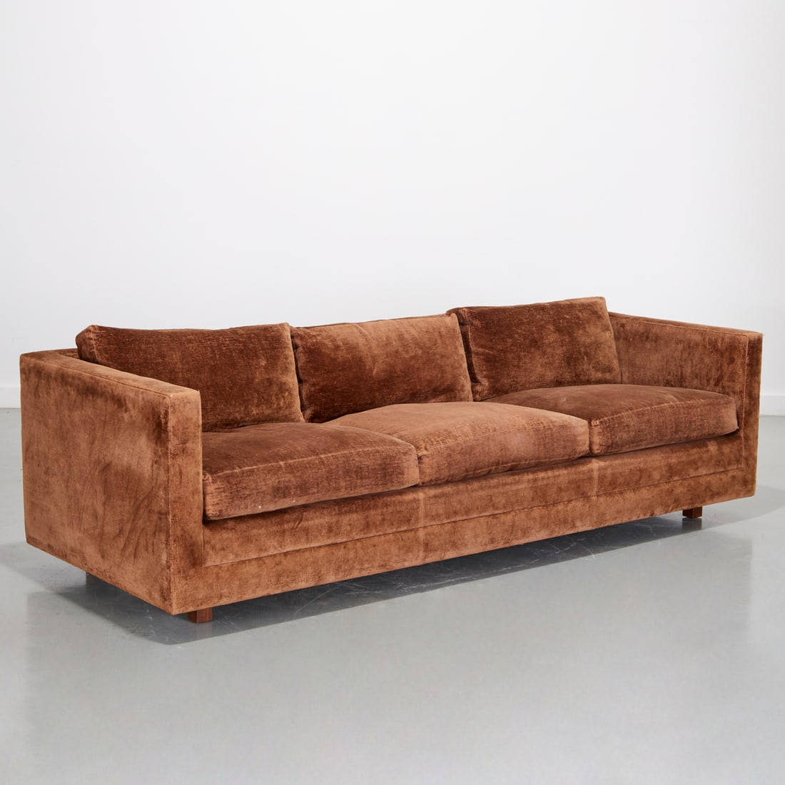 Ward Bennett, three seat sofa: Ward Bennett, three seat sofa, c. 1960s, USA, padded body with three seat and back cushions, upholstered in a brown velvet mohair, raise on inset square wood legs, for Brickell Associates, 25"h x 82"w