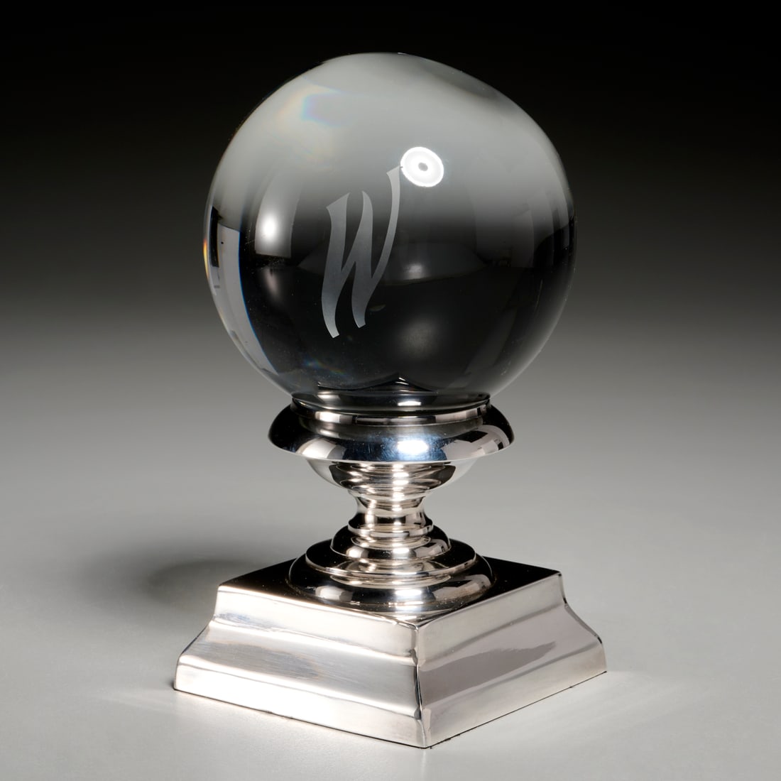 Crystal "W" Ball on stand, Barbara Walters Coll.: Crystal "W" Ball on stand, Barbara Walters Coll., 20th c., polished clear crystal with acid etched monogram "W", silver plated stand, 4"dia (ball), 7"h (total) Provenance: The Estate of Barbara J. Wal
