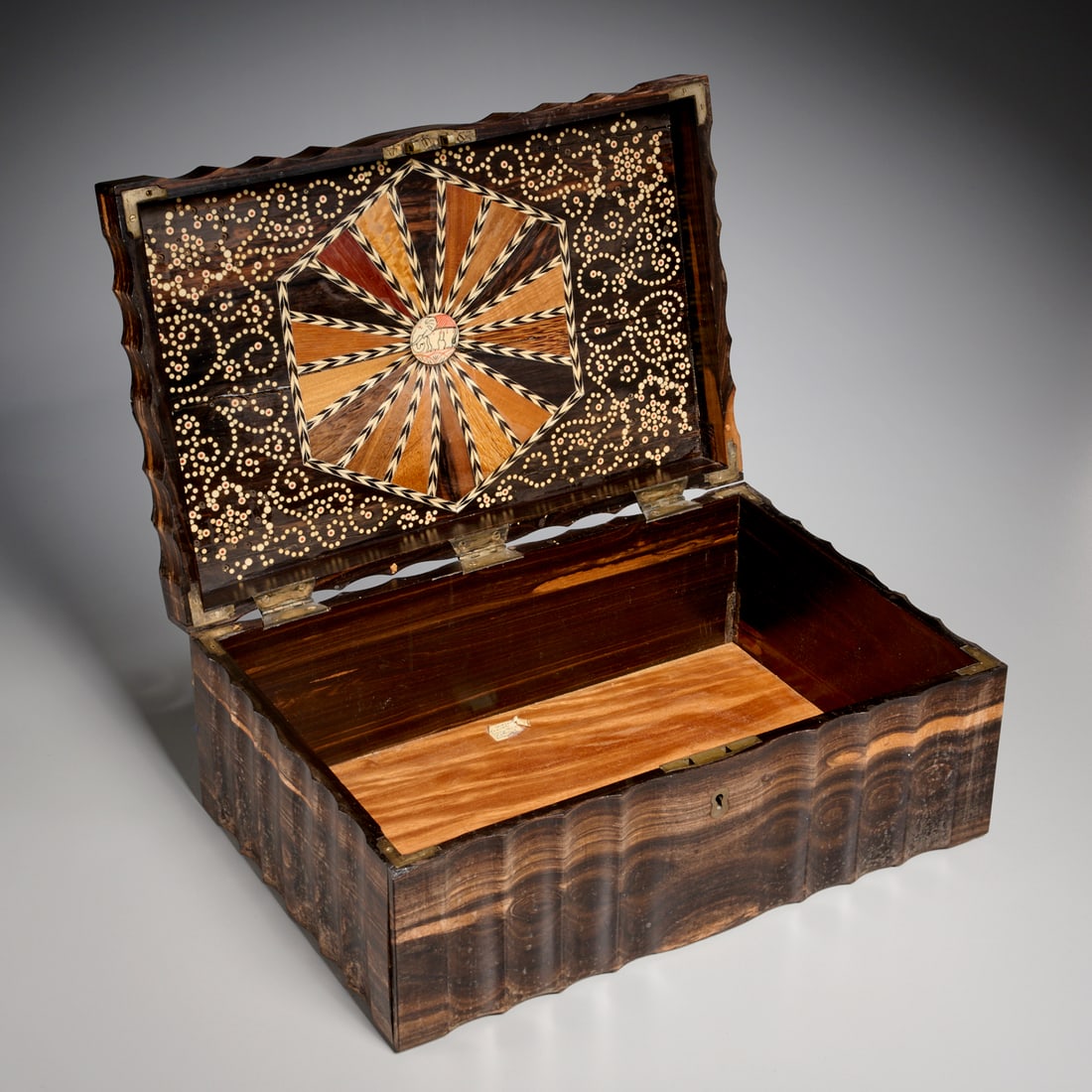 Anglo-Indian ebony Coromandel sewing box: Anglo-Indian ebony Coromandel sewing box, Late 18th c., with fluted sides, silvered hardware, the lid interior inlaid with mixed wood and bone geometric designs, old paper information tag to interior,