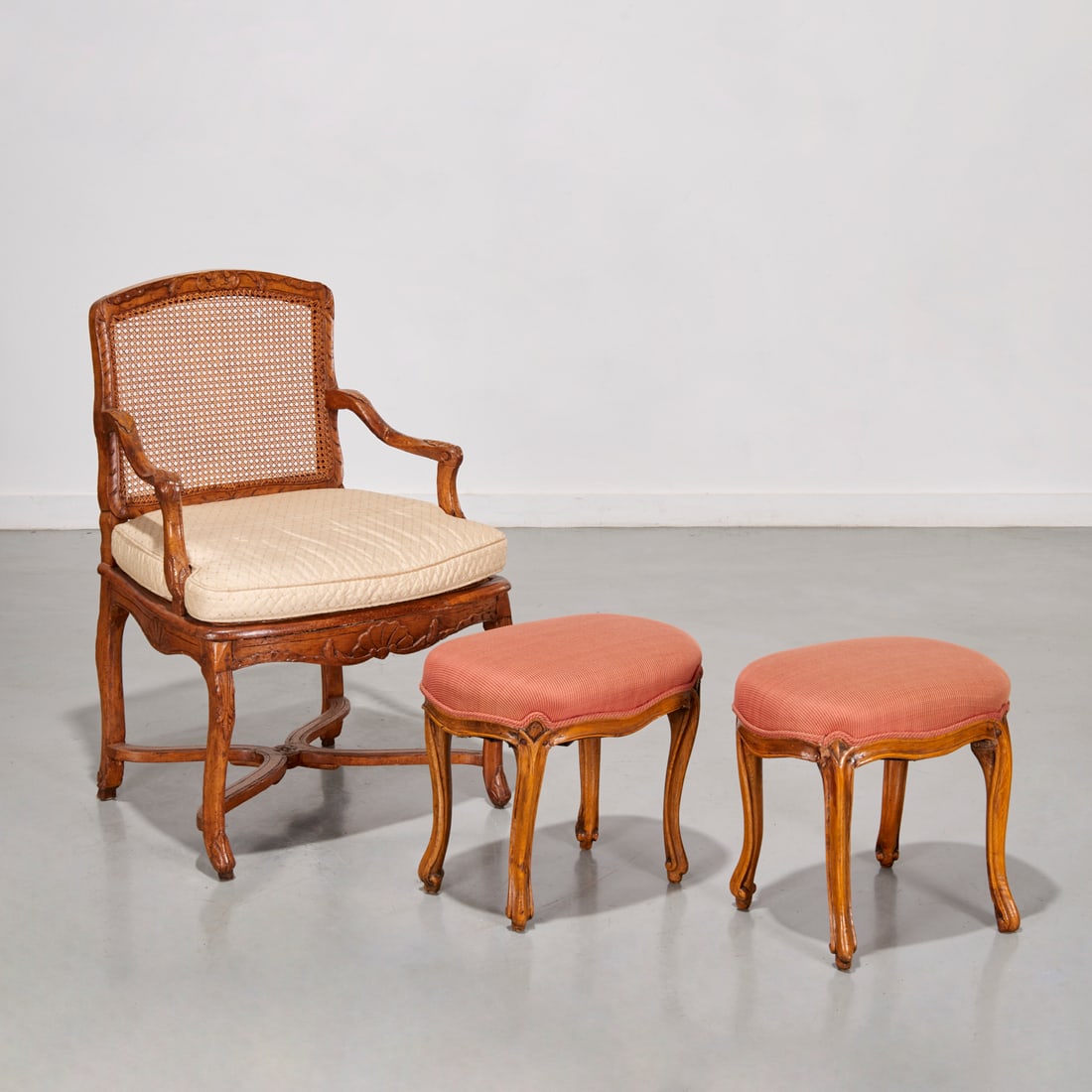 Regence carved beechwood fauteuil and footstools: Regence carved beechwood fauteuil and footstools, 18th - 19th c., France, 36.5"h x 25"w x 18.5"d (fauteuil), 16.25"h x 17.5"w x 12.25"d (stools)