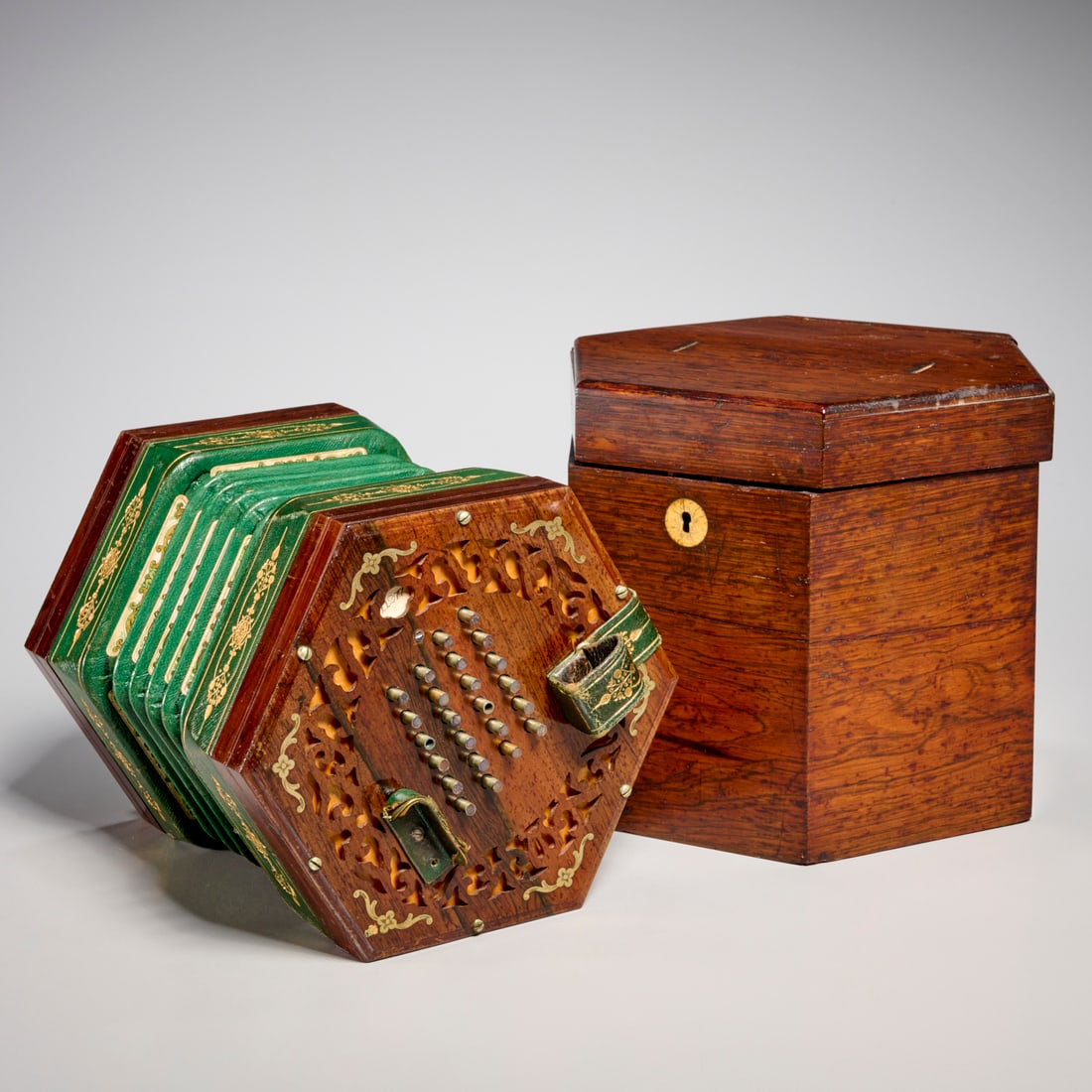 Charles Wheatstone rosewood cased concertina: Charles Wheatstone rosewood cased concertina, 19th c., London, with 24 buttons on either end, tooled green leather bellows, in hinged storage case, labeled on one end of the concertina, 7"h x 8.5"w x