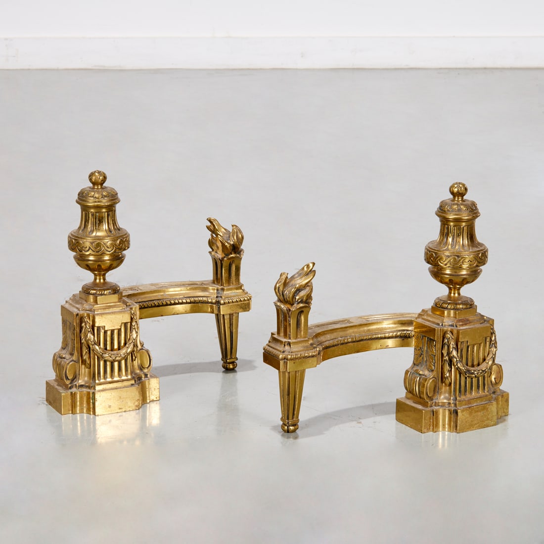 Antique Louis XVI style gilt bronze chenets: Antique Louis XVI style gilt bronze chenets, 19th c., France, urn and torch design, unmarked, 11.75"h x 10.5"l x 5.75"w Provenance: A Private Collection: 550 Park Avenue