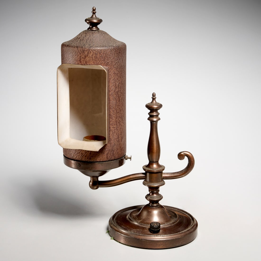 Unusual Emeralite style desk lamp: Unusual Emeralite style desk lamp, Early 20th c., distinctive form, with brown glass cylinder shade, unmarked, 13"h x 9"w x 4.75"d Provenance: A Private New Jersey Collection