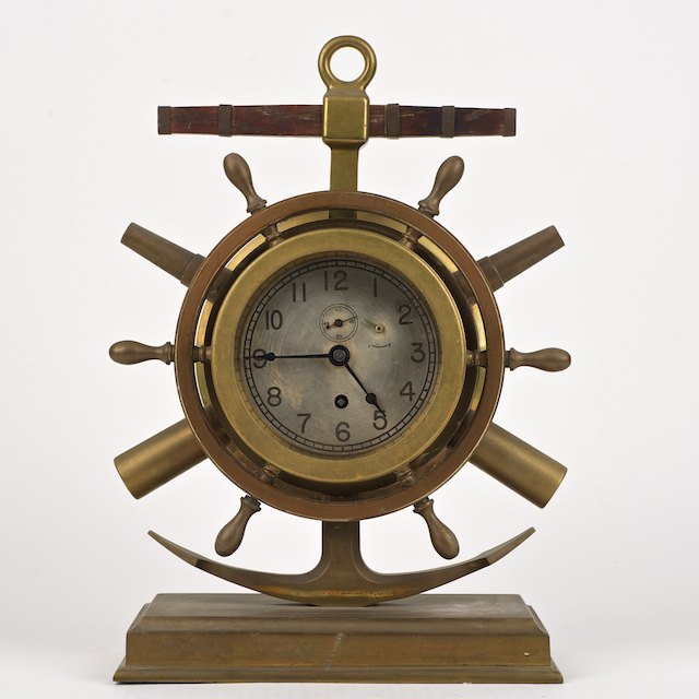 Rare Chelsea ship's wheel, cannon and anchor cloc: Rare Chelsea ship's wheel, cannon and anchor clock: 20th c., no. 24468, brass case, 14.5"h x 10"w x 5"d - Condition Report: overall good, face slightly rubbed, clock works appear in tact but not keepi