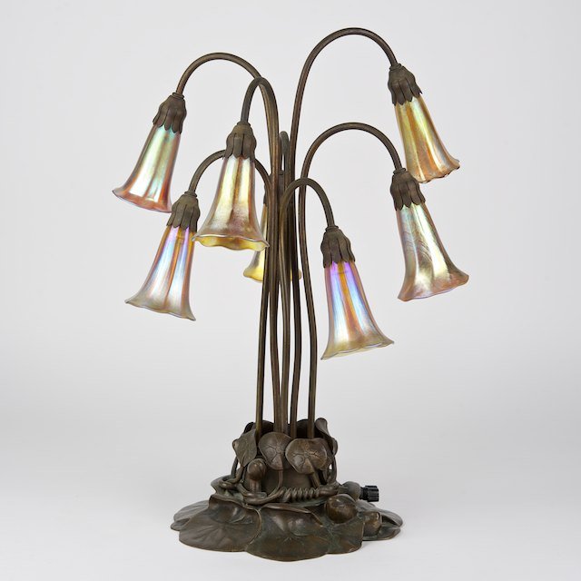 Tiffany Studios seven-light lily lamp: Tiffany Studios seven-light lily lamp: Circa 1910, the brown patinated base stamped "Tiffany Studios, New York 385", 5 of 7 Favrile glass shades signed, 21.25"h x 16"dia. - Condition Report: overall g
