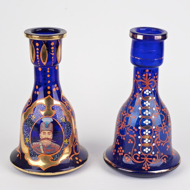 (2) Qajar enameled cobalt blue glass hookah bases: (2) Qajar enameled cobalt blue glass hookah bases: Late 19th c., one with Shah Naser al-Din portrait, 10.5"h x 6"dia. - Condition Report: overall good/fair, gilding and enamel rubbed, no damage or rep