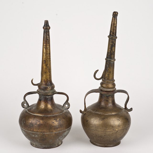 (2) similar Islamic bronze rose water bottles: (2) similar Islamic bronze rose water bottles: Prob. 18th/19th c., 14.5"h x 5.75"dia. (larger) - Condition Report: overall fair, possible repair, small dents