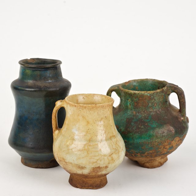 (3) early Islamic pottery jars ex. Kevorkian Coll: (3) early Islamic pottery jars ex. Kevorkian Collection: Prob. 12th/13th c., Rakka ware and Sultanabad, 4.75"h x 3"dia. (largest), 3.75"h x 3" dia. (smallest) - Condition Report: overall fair, possibl