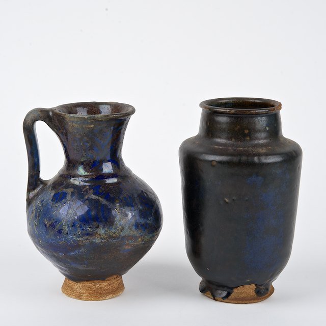 (2) Islamic glazed pottery vessels: (2) Islamic glazed pottery vessels: Poss. 13th c., incl. Rhages ware, one with luster decoration, 7"h x 4" dia. (jar), 6.75"h x 5" dia. (jug) - Condition Report: overall fair/poor, crazing, mineral/li