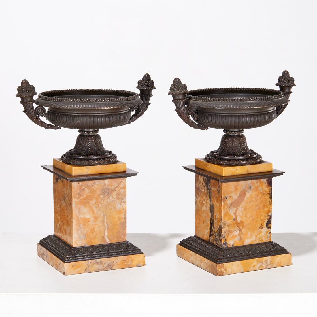 Pair Charles X bronze and marble tazze: Pair Charles X bronze and marble tazze, 19th c., dark brown patina with siena marble bases, 12.5"h x 9.5"w x 7"d
