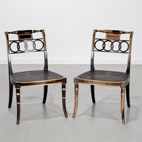 Pair Baker ebonized and caned side chairs
