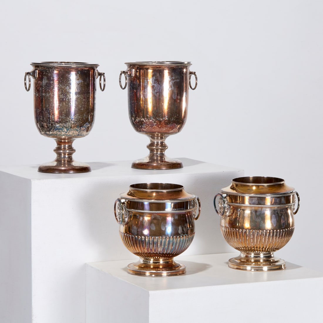 (2) Pairs Sheffield plate wine coolers, ex museum: (2) Pairs Sheffield plate wine coolers, ex museum, 19th/20th c., England, two pairs silver plate bottle coolers, incl. a tall pair engraved with hand and sword armorial, and a shorter pair with Bacchu