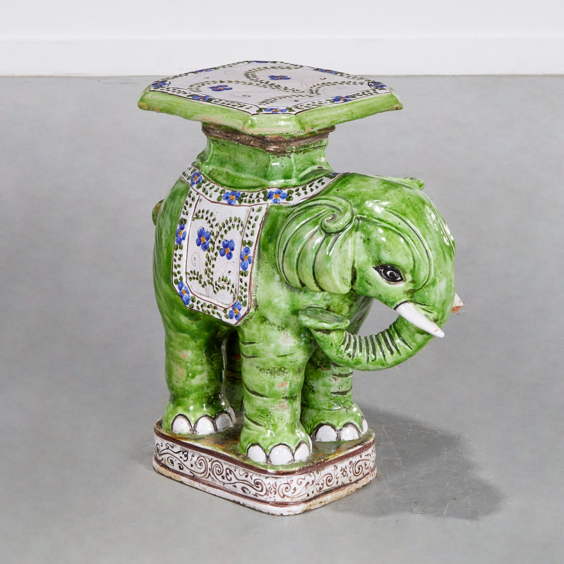 Italian majolica elephant garden seat: Italian majolica elephant garden seat, 20th c., glazed terracotta, floral and vine decoration, unmarked, 23"h x 22"l x 11.5"w