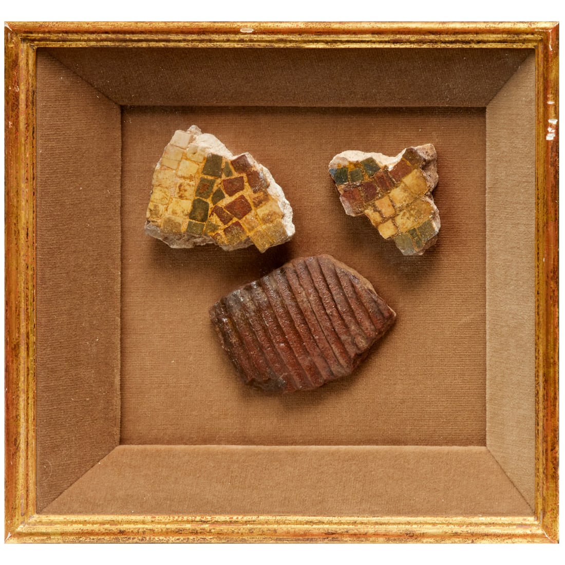 Pompeian style mosaic and tile fragments: Pompeian style mosaic and tile fragments, Italy, possibly of the period, two mosaic fragments, 3"l x 2.25"w (larger) and one tile fragment, 3.5"l x 2.5"w, all mounted in shadowbox frame, 10.25"h x 11"