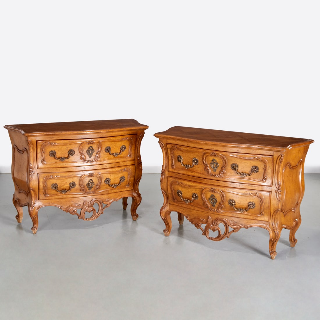 Auffray & Co., pair Louis XV style walnut commodes: Auffray & Co., pair Louis XV style walnut commodes, c. 1960s, carved serpentine case with parquet top, metal placard label to drawer interior, 34"h x 47.5"w x 21"d