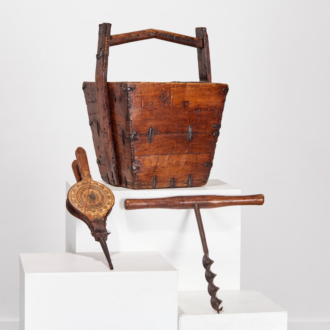Antique rustic woodenware group: Antique rustic woodenware group, 19th/20th c., incl. a Chinese rice bucket, a primitive auger, and a chip carved bellows, 23.5"h x 18"w x 16.5"d