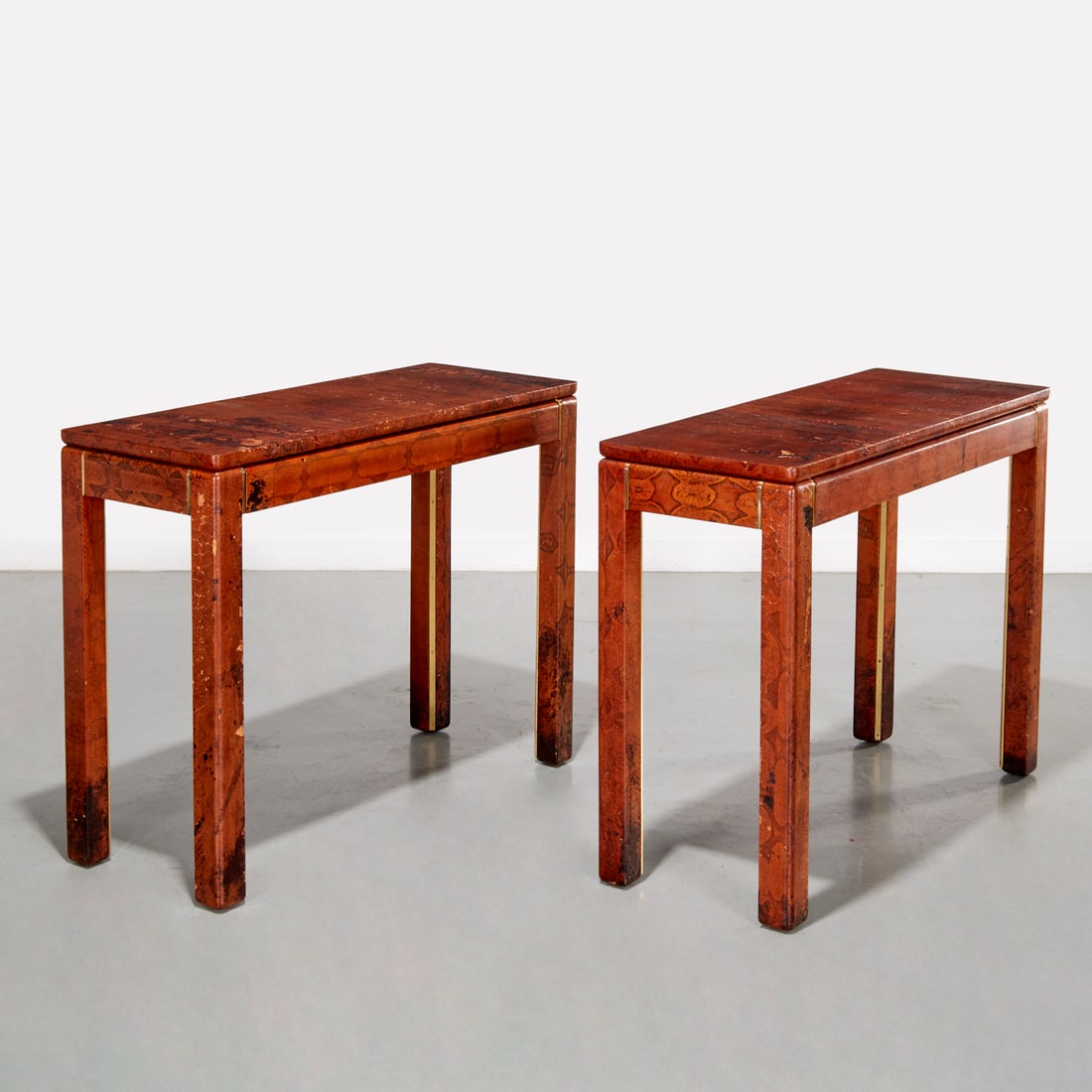 Karl Springer (attrib.), red python console tables: Karl Springer (attrib.), red python console tables, c. 1970s/1980s, parsons style with rounded corners, single long drawer, and brass trim, unmarked, 32.5'h x 42"w x 16"d Provenance: A Billy Baldwin C