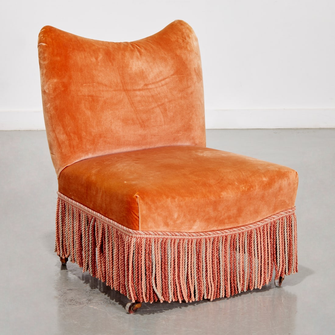 Napoleon III velvet slipper chair: Napoleon III velvet slipper chair, 19th/20th c., salmon velvet upholstery with tassel trim, gold painted wood legs ending on casters, unmarked, 28.5"h x 22"w x 21.5"d Provenance: Property from LuShan 