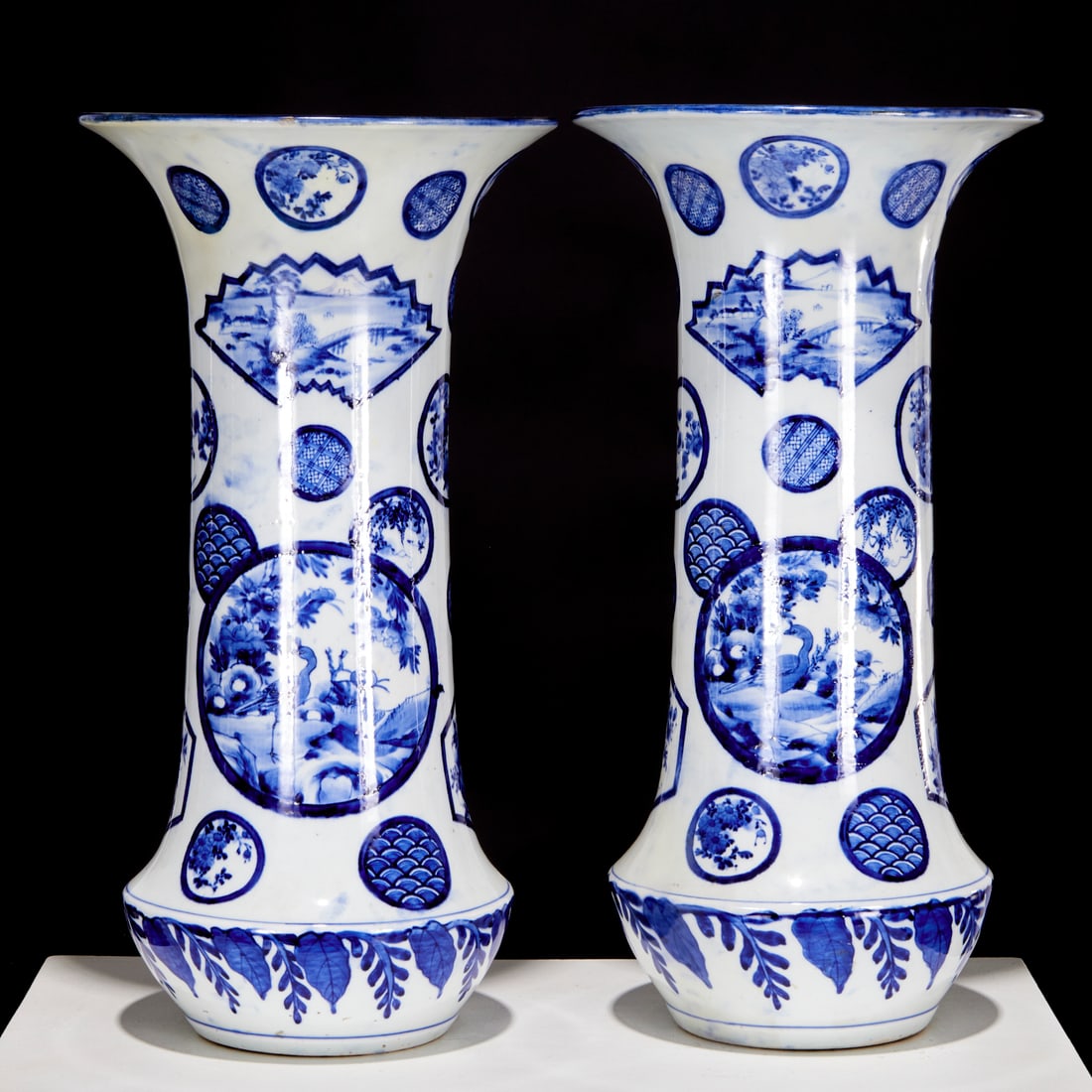 Pair large Japanese blue and white gu vases: Pair large Japanese blue and white gu vases, 19th/20th c., blue underglazed white porcelain, heavily potted beaker vases decorated with panels and roundels of birds, foliage and landscapes, geometric 