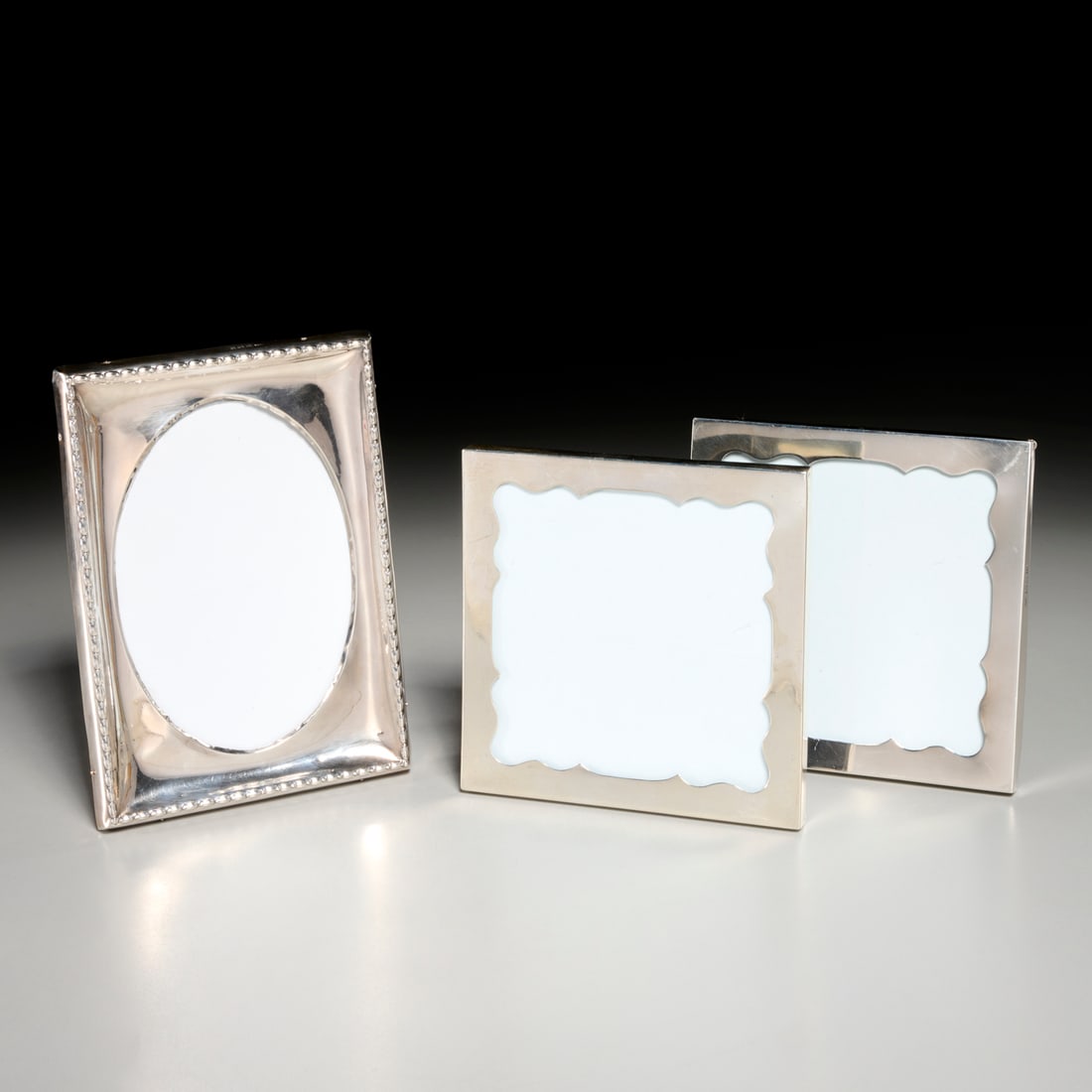 (3) Edwardian style sterling picture frames: (3) Edwardian style sterling picture frames, Early 20th c., London, incl. a pair of Goldsmiths & Silversmiths Company small square frames, hallmarked, c. 1908, 5.5"squ., and a single rectangular frame