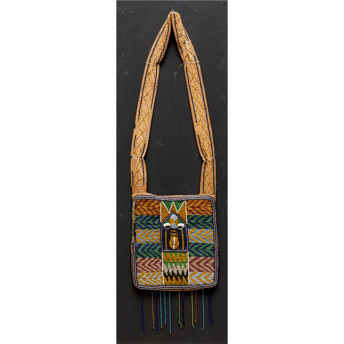 Yoruba People, beaded Yata dance panel: Yoruba People, beaded Yata dance panel, 19th/20th c, Nigeria, trade cloth, trade beads, fiber, the central motif depicting the head of Eshu, the god of chance, on display board, information label vers