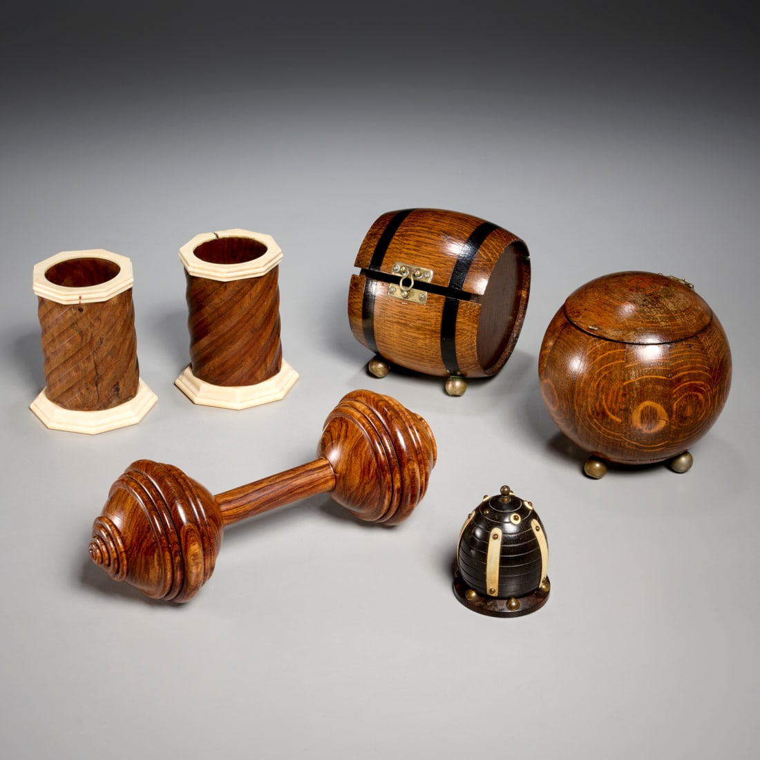 (6) Antique treenware table accessories: (6) Antique treenware table accessories, 19th c., (6) pieces, incl. a turned ebony egg-shaped thread box with brass interior spool, pair of cups with octagonal mounts, two oak boxes with hinged lids,