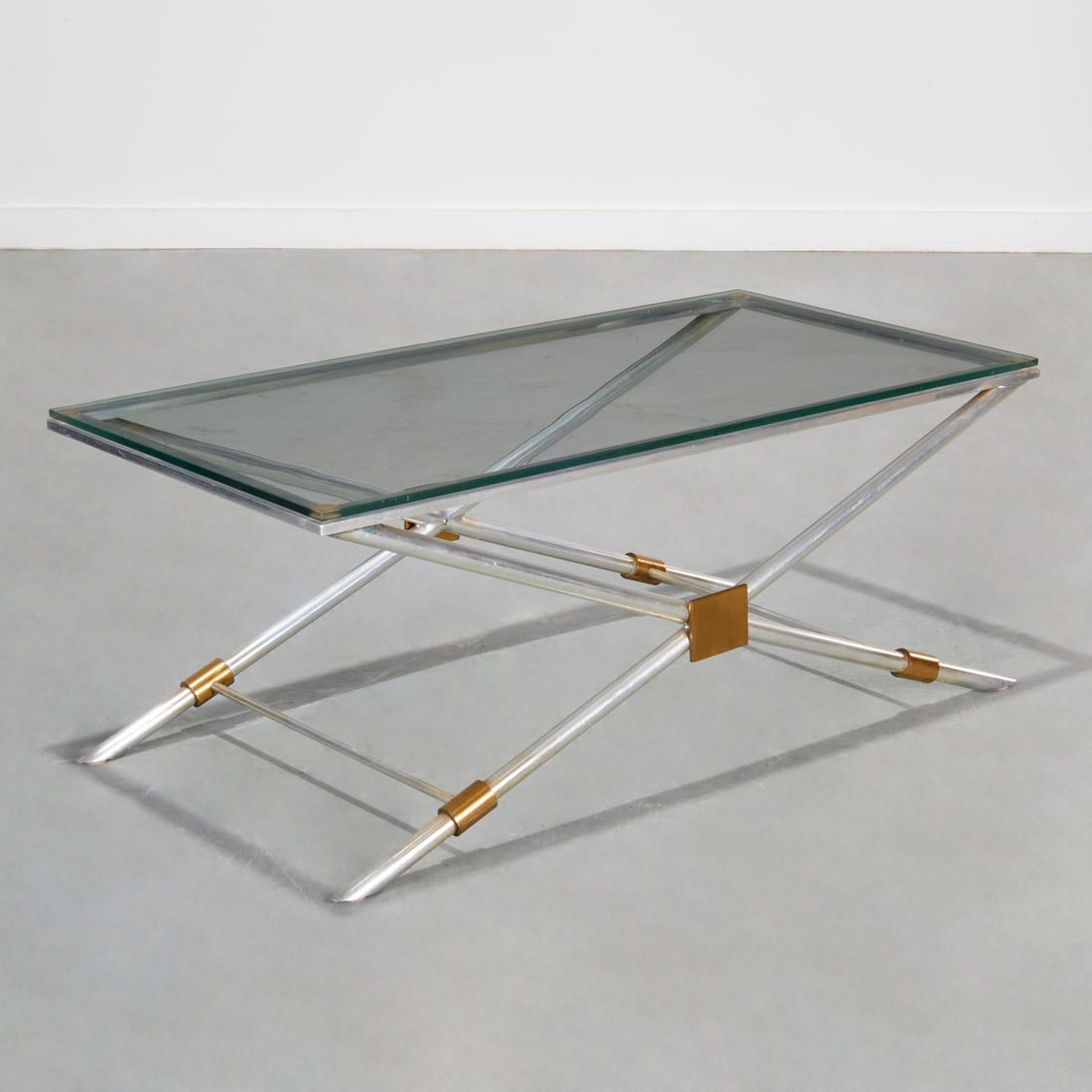 John Vesey, rare V-41 coffee table: John Vesey, rare V-41 coffee table, c. 1958, USA, rectangular plate glass top on aluminum X-form base with brass fittings, unmarked, 17.5"h x 44"w x 22"d
