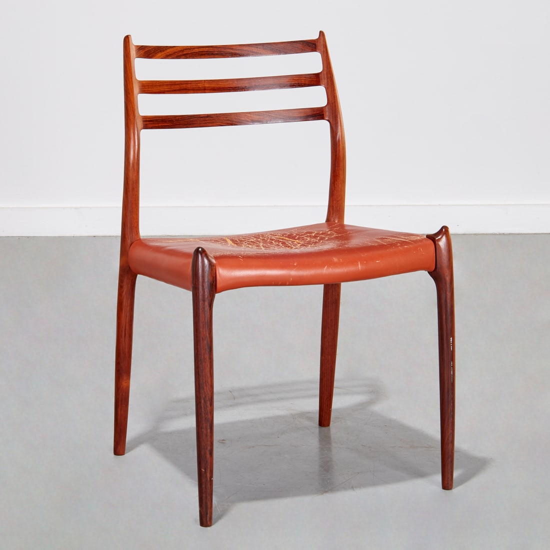 Niels Moller Model 78 rosewood side chair: Niels Moller Model 78 rosewood side chair, c. 1950s, Denmark, red leather upholstered seat, marked interior underside frame, 31.5"h x 19"w x 17"d, 18"h (seat height) Provenance: A Private Collection: