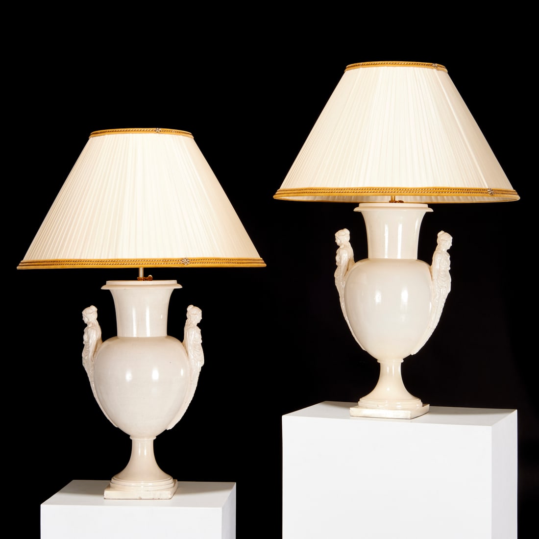 Pair large antique creamware urn lamps: Pair large antique creamware urn lamps, 19th c., and adapted, pedestal urns with term figure handles, later mounted as two light table lamps, no visible marks, 41.5"h x 27.5"dia (total), 16"h x 27.5"d