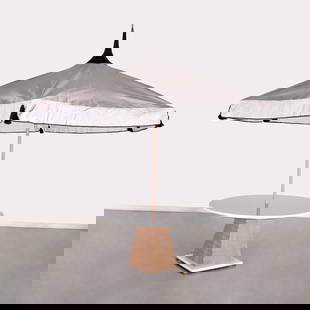 Contemporary patio table with Tuuci umbrella: Contemporary patio table with Tuuci umbrella, 20th/21st c., supplied by Alberto Pinto, round white enamel top on ribbed faux wood pyramidal base with steel plinth, fitted with a Tuuci umbrella, unmark