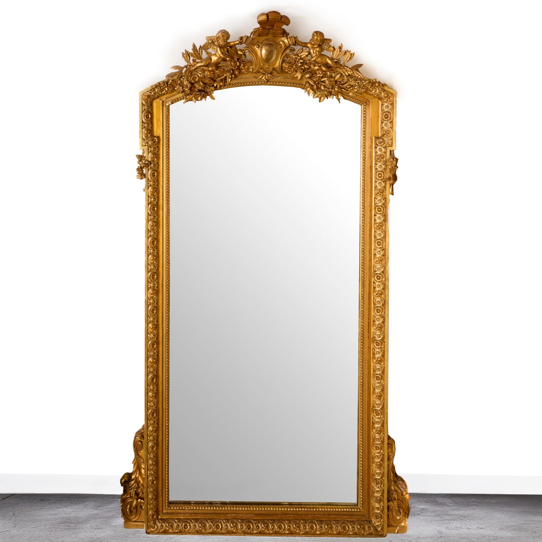 Monumental Napoleon III giltwood pier mirror: Monumental Napoleon III giltwood pier mirror, 19th c., supplied by Alberto Pinto, the crest with feather plume and central cartouche flanked by cherubs and foliate sprays, over mirror plate with entre