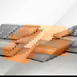 Italian Modern leather loveseat and ottoman: Italian Modern leather loveseat and ottoman, 20th c., loose foam-filled seat and back cushions, raised on squat wood block feet, ottoman on castors, 26"h x 72"l x 40"d, 16"h (to seat), 15"h x 30"w x 2
