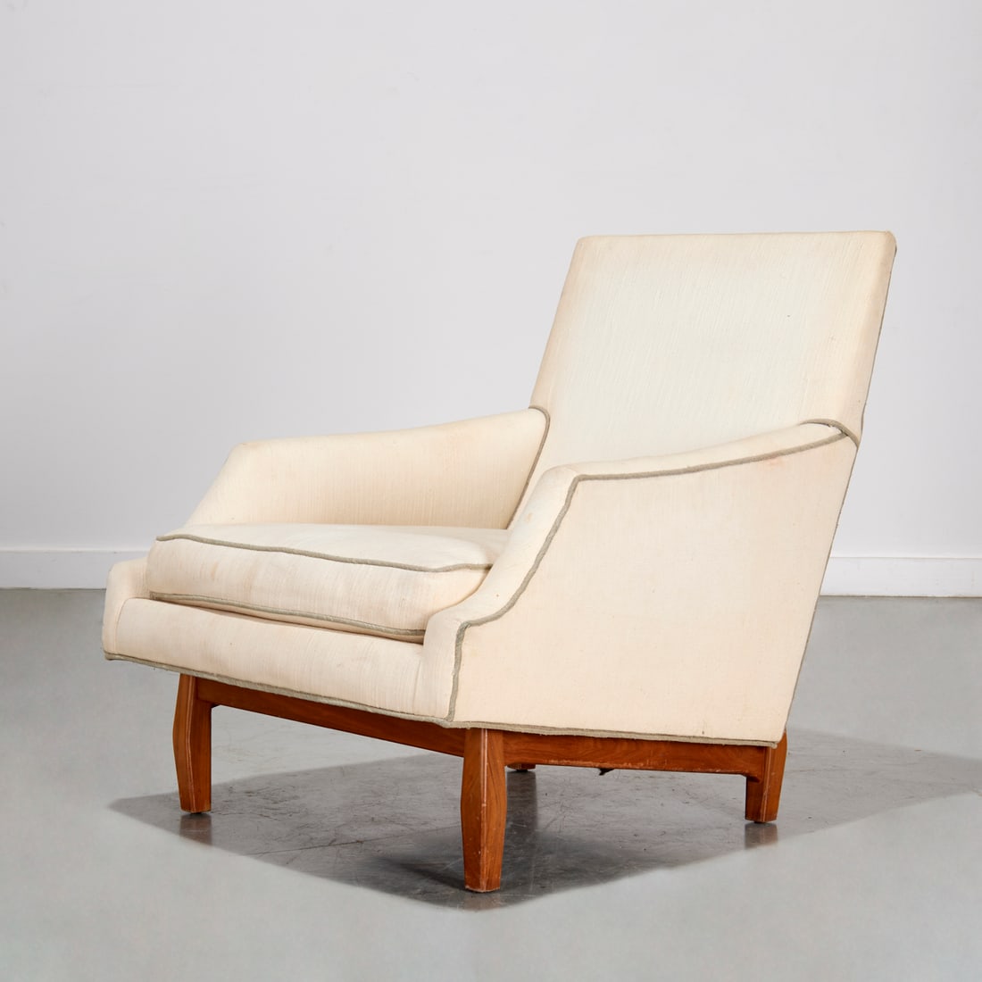 Dunbar style walnut lounge chair: Dunbar style walnut lounge chair, Mid-20th c., USA, high back lounge chair, with cream upholstery, unmarked, 32.5"h x 29.5"w x 32"d