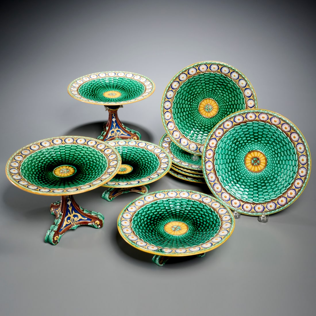 Wedgwood majolica "Stanley" dinnerware: Wedgwood majolica "Stanley" dinnerware, Late 19th c., England, (10) pieces, incl. two pairs of tazze, and (6) matching plates, 6"h x 8.5"dia (larger tazza), 8.75"dia (plates) Provenance: The Iris Apfe