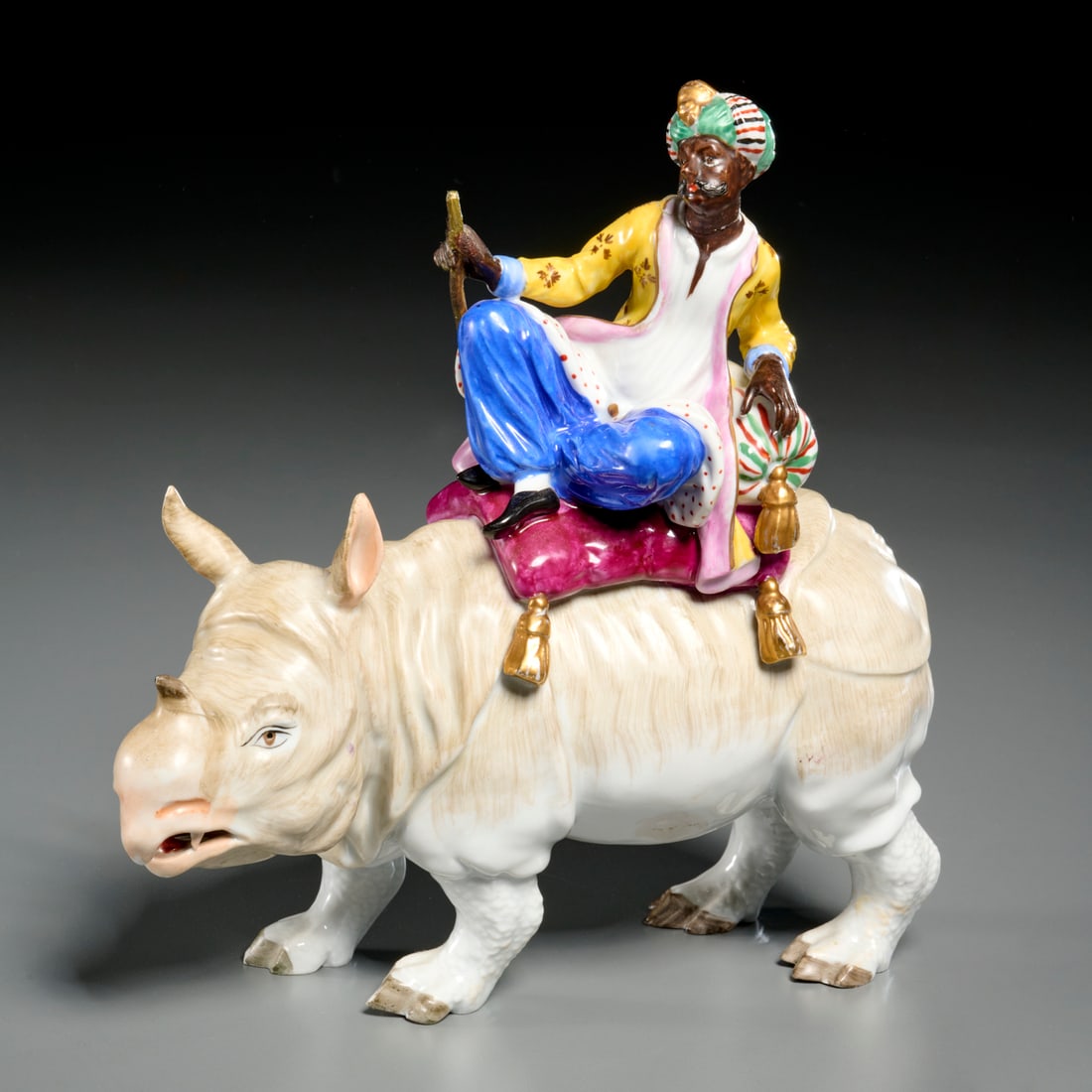 Carl Thieme, Orientalist porcelain figure: Carl Thieme, Orientalist porcelain figure, 20th c., Germany, after a Meissen model by J.J. Kaendler, mahout riding a rhinoceros, underglaze blue factory mark to underside, 8.25"h x 8.25"l x 3"w Proven