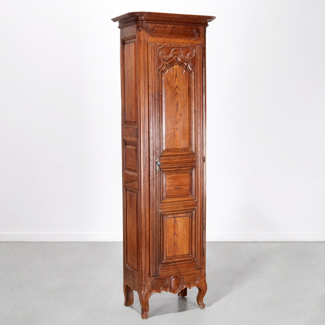 Louis XV Provincial carved bonnetiere: Louis XV Provincial carved bonnetiere, 18th/19th c., single door, interior fitted with shelves and single drawer, approx. 84.5"h x 26.25"w x 17.25"d Provenance: The Iris Apfel Collection