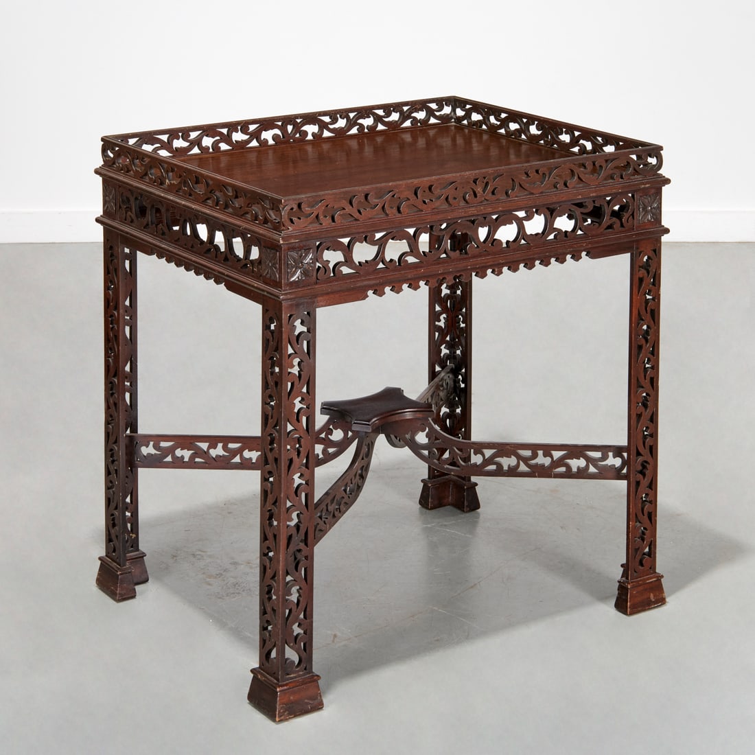 Antique George III style open fretted tea table: Antique George III style open fretted tea table, 20th c., rectangular top with open fretted gallery, on similarly designed legs joined by stretchers, unmarked, 32"h x 30.25"l x 24.25"w Provenance: The