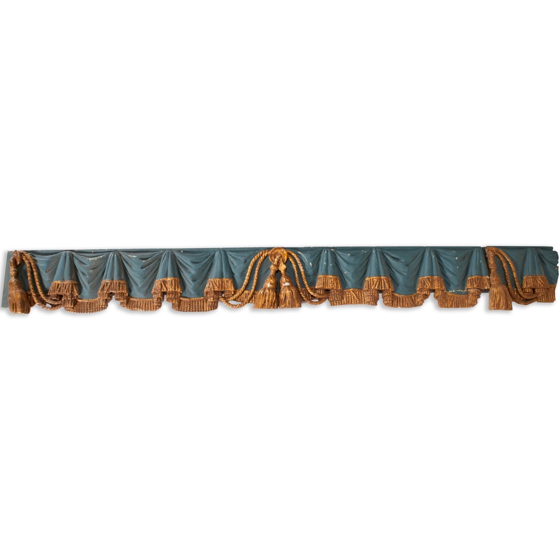 Continental trompe l'oeil window treatment: Continental trompe l'oeil window treatment, 20th c., wood carving, blue painted and parcel gilt, curtain fold with tassel trim, unmarked, 12"h x 104.5"w x 4"d Provenance: The Iris Apfel Collection