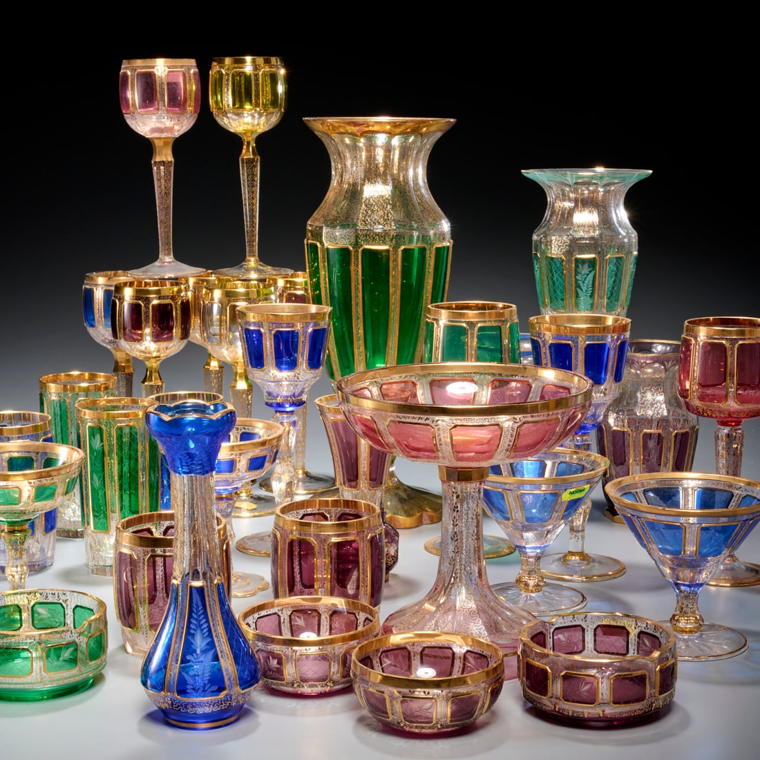 Bohemian gilt decorated glassware collection: Bohemian gilt decorated glassware collection, 20th c., Czech Republic, Kamenicky Senov and others, gilt decorated colorless glass with cobalt, green, and ruby flash glass, (31) pieces, incl. (4) varie