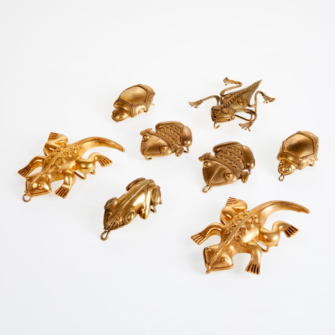 Group of Ashanti-style gold tone buckles: Group of Ashanti-style gold tone buckles, 21st c. (4) pairs, in figural form including beetles, frogs, lizards, largest, 4.5"l, fits 1"-2" belt strap Provenance: The Iris Apfel Collection