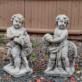 (2) Cast stone shepherd putto garden statues