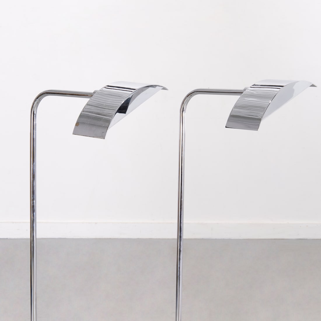 Pair Christian Liaigre CL4 floor lamps: Pair Christian Liaigre CL4 floor lamps, Late 20th c., chromed body with partial domed shade, on bar foot, no signature observed, each 37"h x 9"w x 11.5"d