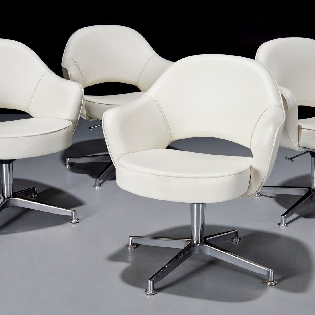 Eero Saarinen for Knoll, (4) swivel armchairs: Eero Saarinen for Knoll, (4) swivel armchairs, 21st c., "Executive" swivel chairs in white leather with chrome base, adjustable height, Knoll tags underneath each, 32.5"-35.5"h x 27"w x 24"d, 18.5"-21
