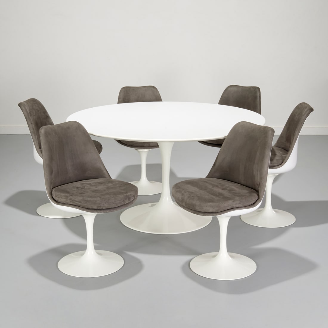 Eero Saarinen for Knoll "Tulip" table and chairs: Eero Saarinen for Knoll "Tulip" table and chairs, 20th/21st c., white lacquer, marked underside, incl. (6) chairs with gunmetal gray suede upholstery, marked under cushion, 29"h x 53.75"dia (table), 3