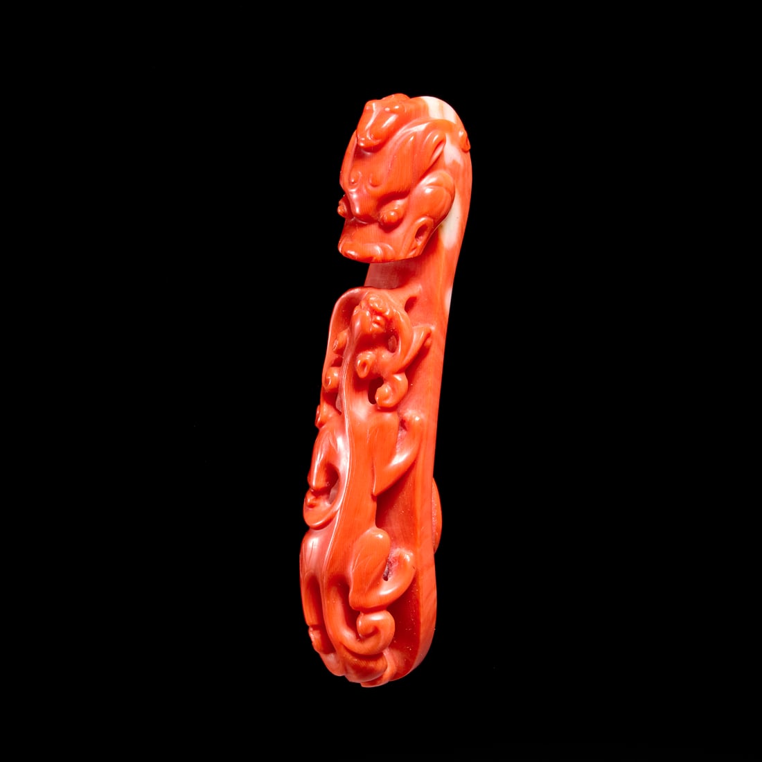 Chinese carved coral belthook: Chinese carved coral belthook, 19th/20th c., carved dark orange coral, dragon form, paper inventory label verso, 3.25"l x .75"w Provenance: A Private Collection: 1040 Fifth Avenue, NYC