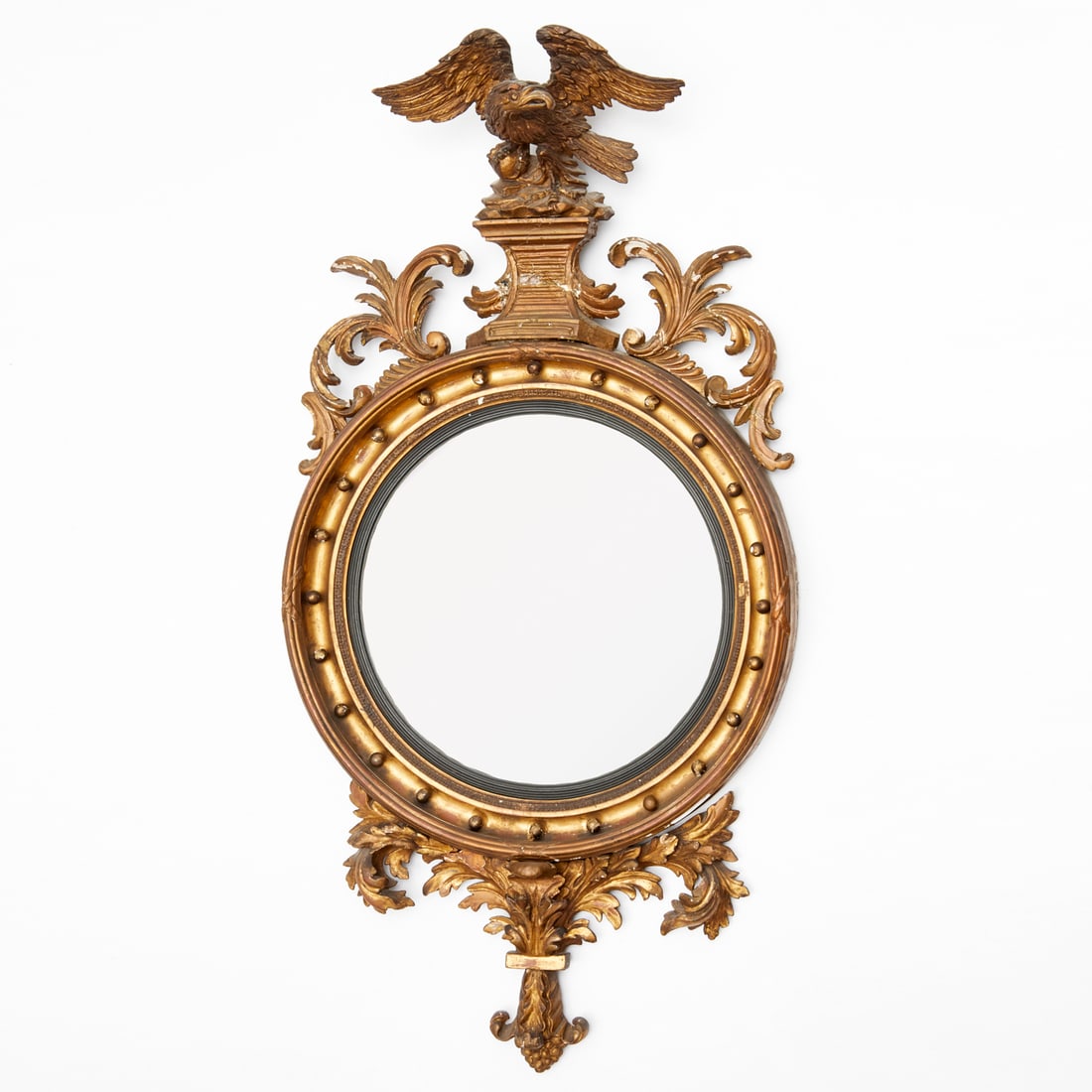 Federal giltwood convex mirror: Federal giltwood convex mirror, 19th c., likely USA, convex mirror, carved eagle crest, giltwood surround, unmarked, 54"h x 27"w x 9"d