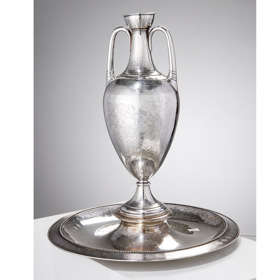 Victorian sterling silver amphora vase and stand: Victorian sterling silver amphora vase and stand, c. 1873, stand, 1875, vase, London, each with maker's mark of Robert Hennell, the double handled pedestal vase engraved with Grecian figure on horse d