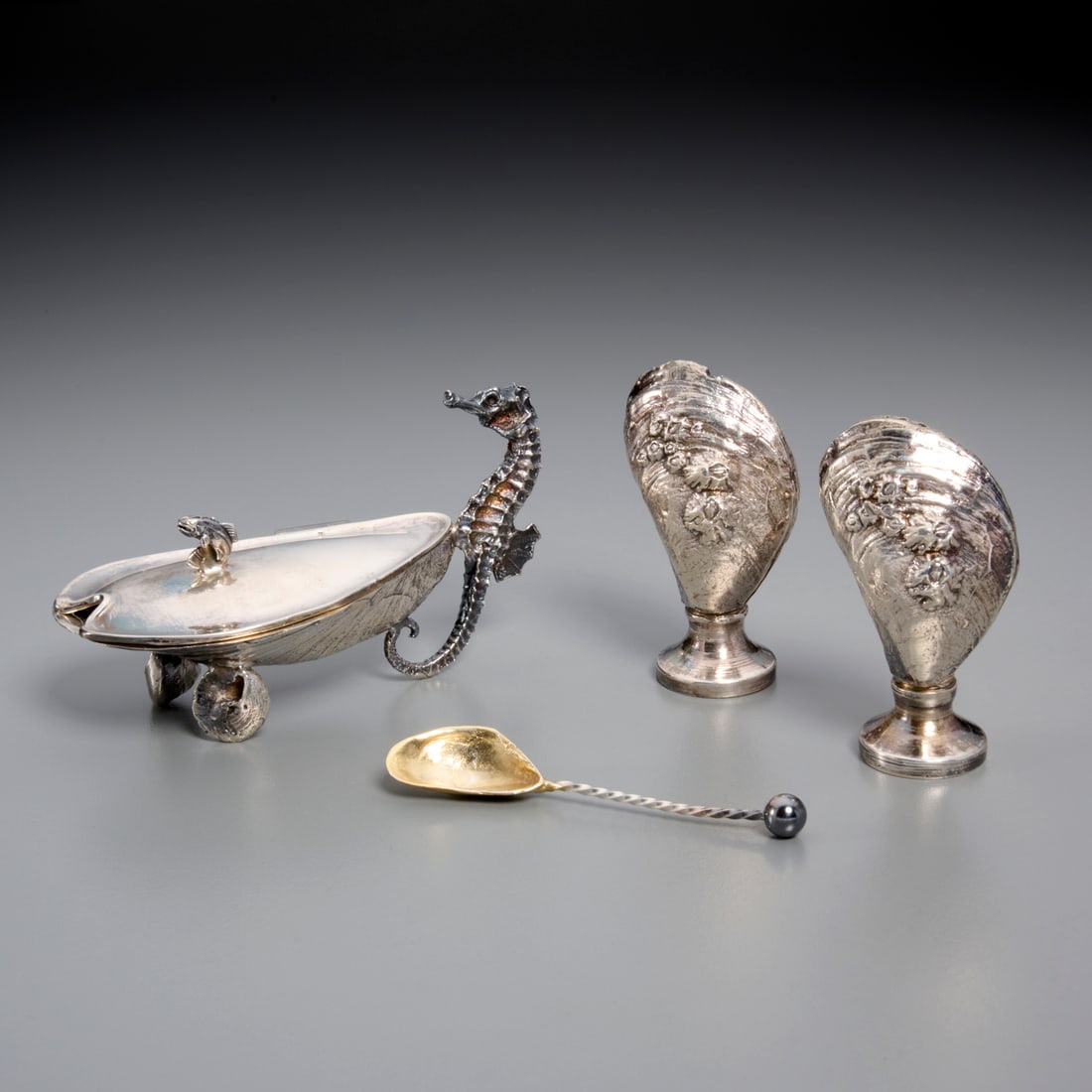 (3) English sterling "Grotto" shakers and cellar: (3) English sterling "Grotto" shakers and cellar, Letter dated for 1972, London, mark of SMD Castings, incl. (1) Pair of repousse mollusk salt and pepper shakers, (1) shell with seahorse handle salt c