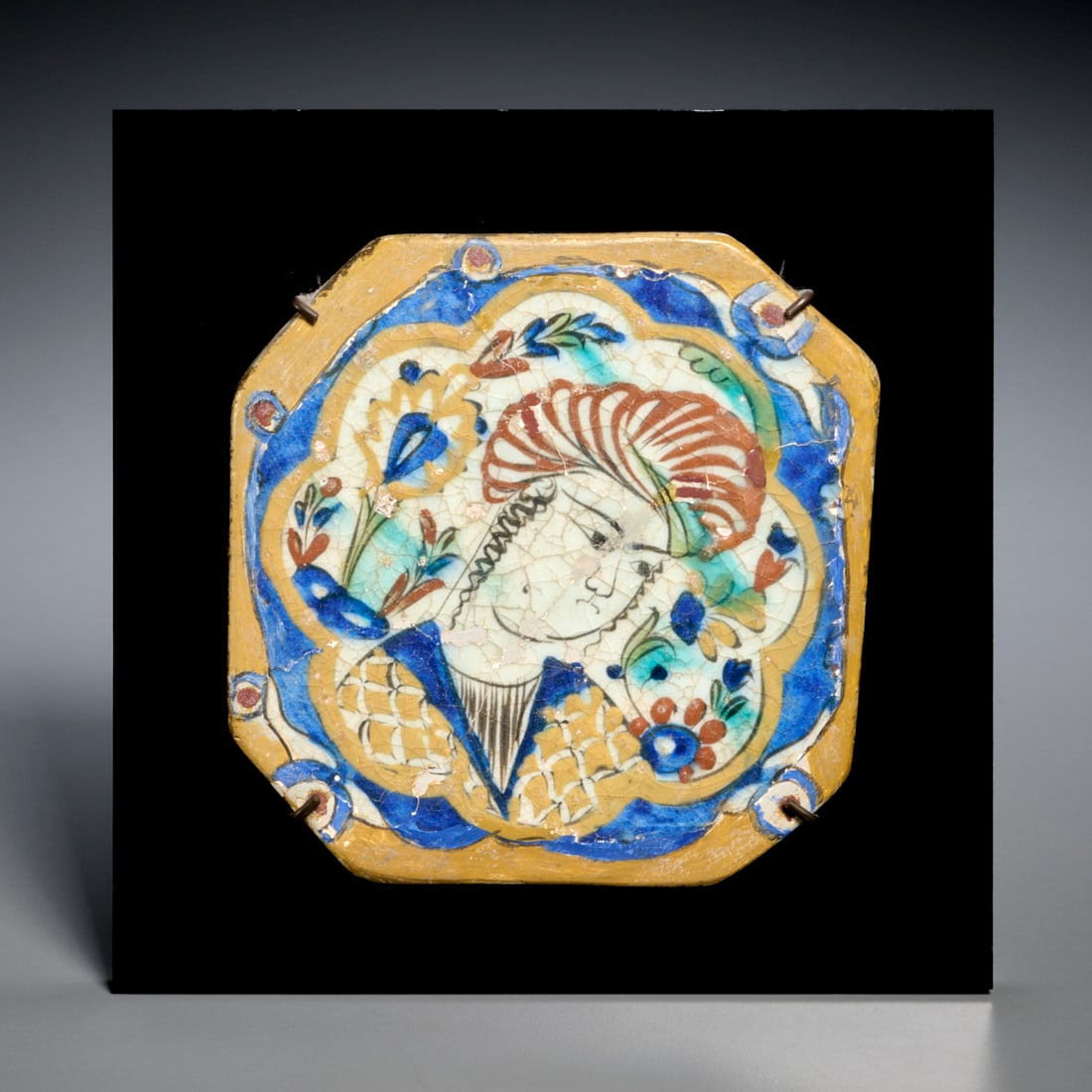Safavid period Kubachi tile, ex Sotheby's: Safavid period Kubachi tile, ex Sotheby's, 17th c., Persia/Turkey, square form ceramic tiles depicting central lobed cartouche with figure amongst vegetal motifs, Sotheby's lot sticker verso, mounted