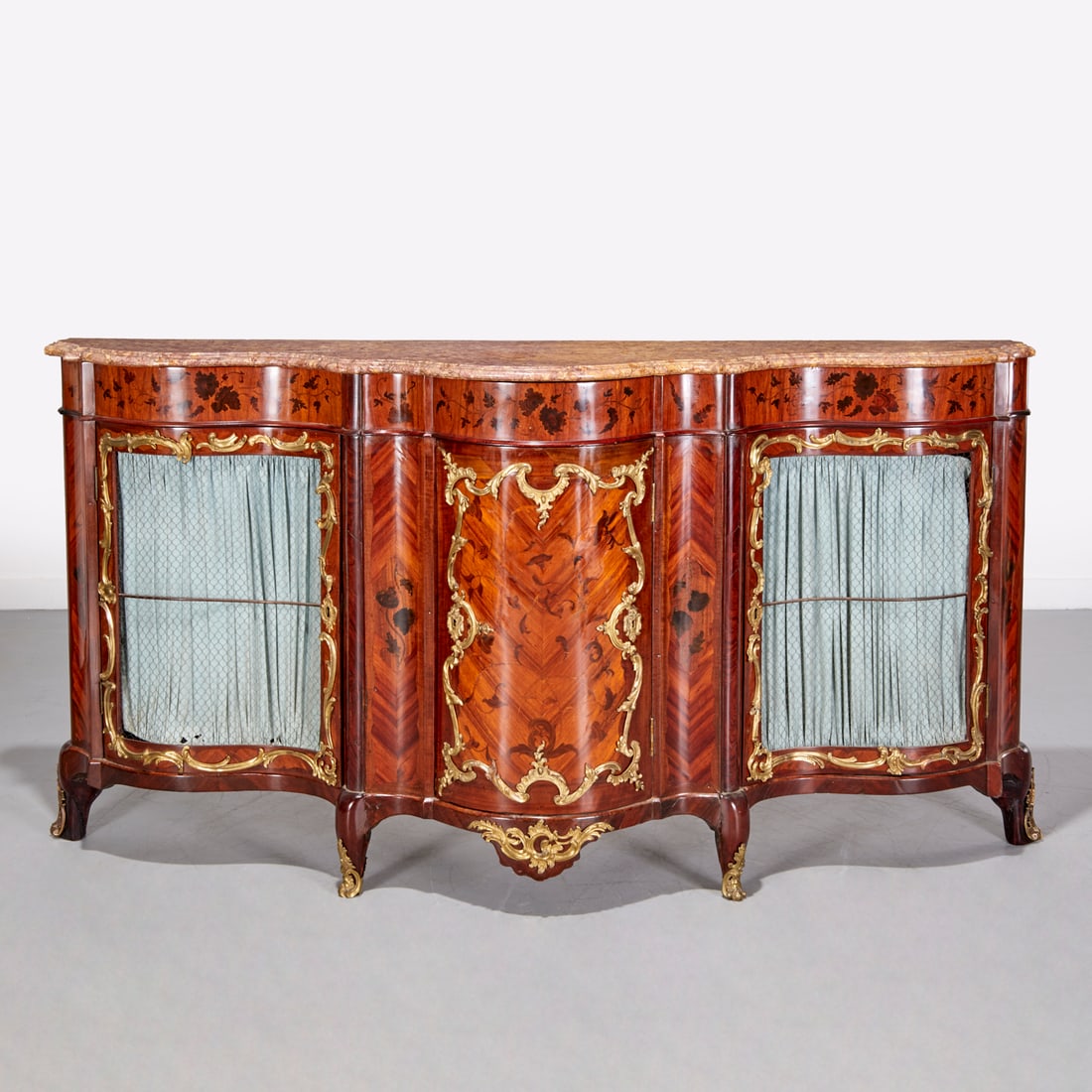 Louis XV marble top and marquetry buffet: Louis XV marble top and marquetry buffet, 18th/19th c., France, fossil marble top, serpentine front, foliate marquetry throughout, three doors revealing interior shelves, ormolu rocaille mounted, flan